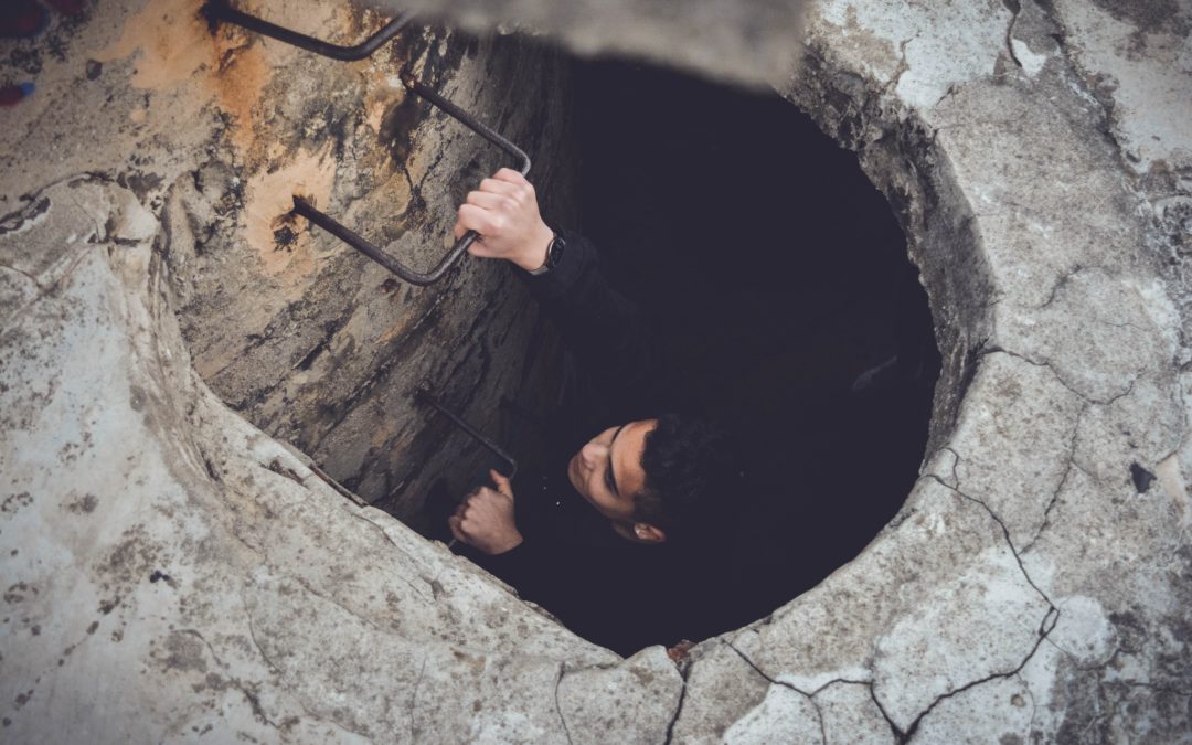 Image of climbing out of a hole