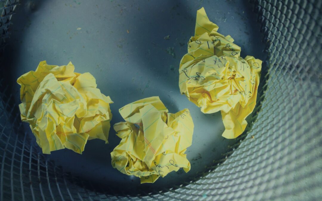 Image of crumpled-up paper in a wastebasket