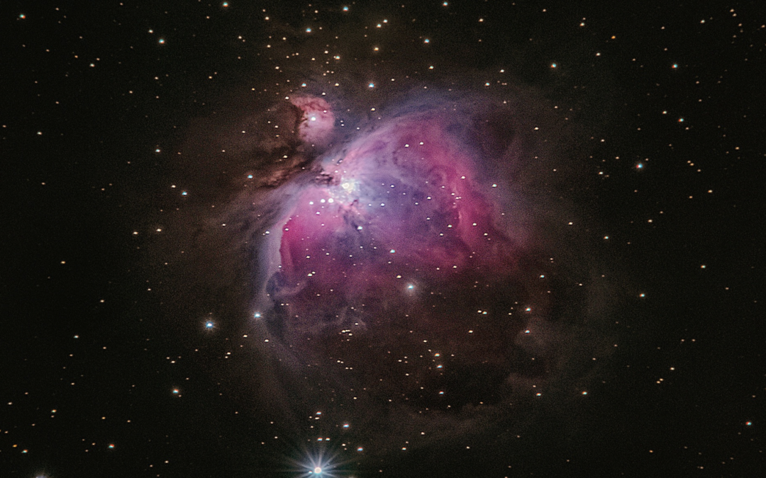 Image of a nebula erupting in the darkness