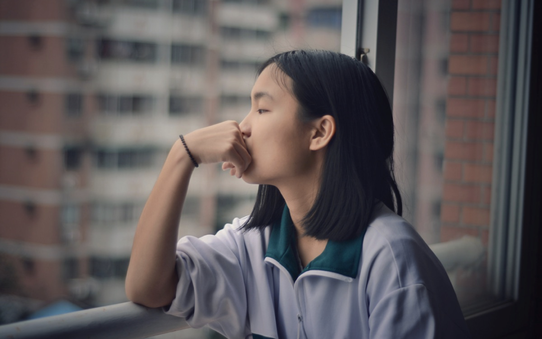 Image of a woman looking out of a hospital window