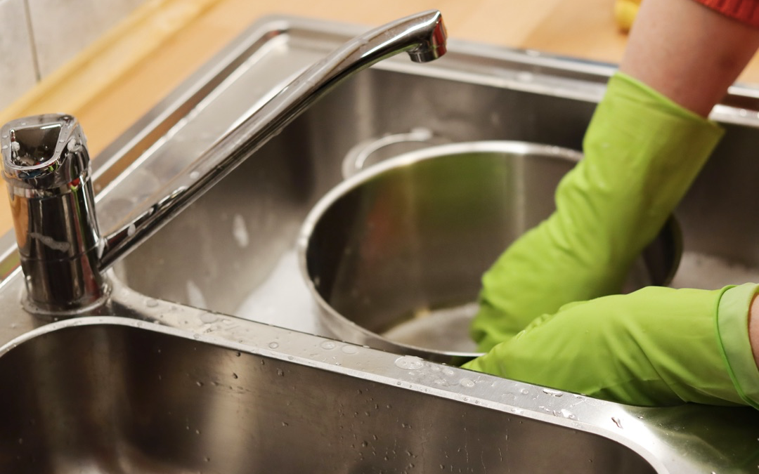 Image of a person washing dishes
