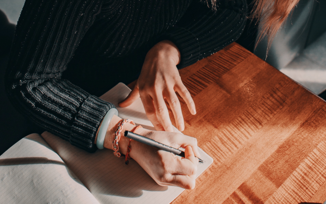 Image of a person writing on a blank page